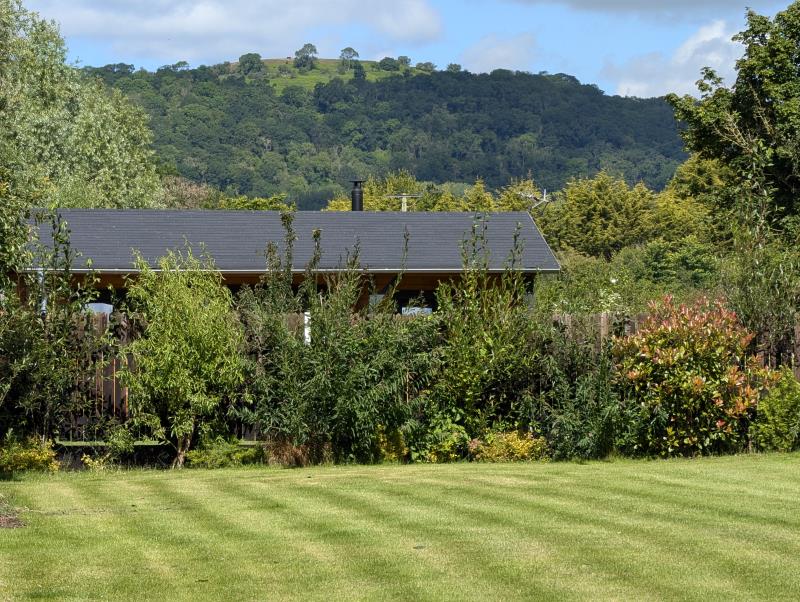 The superior pitch with the Courtyard Cabins and The Malvern Hills beyond